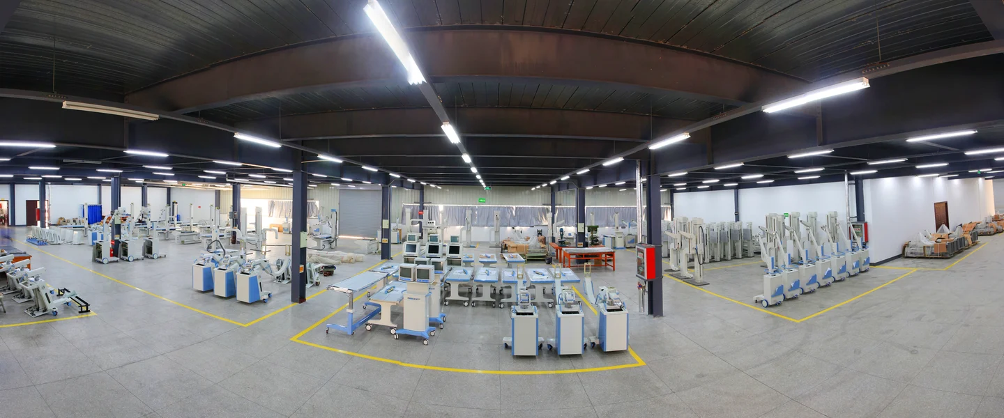 Imaging equipment and examination tables in a production workshop.