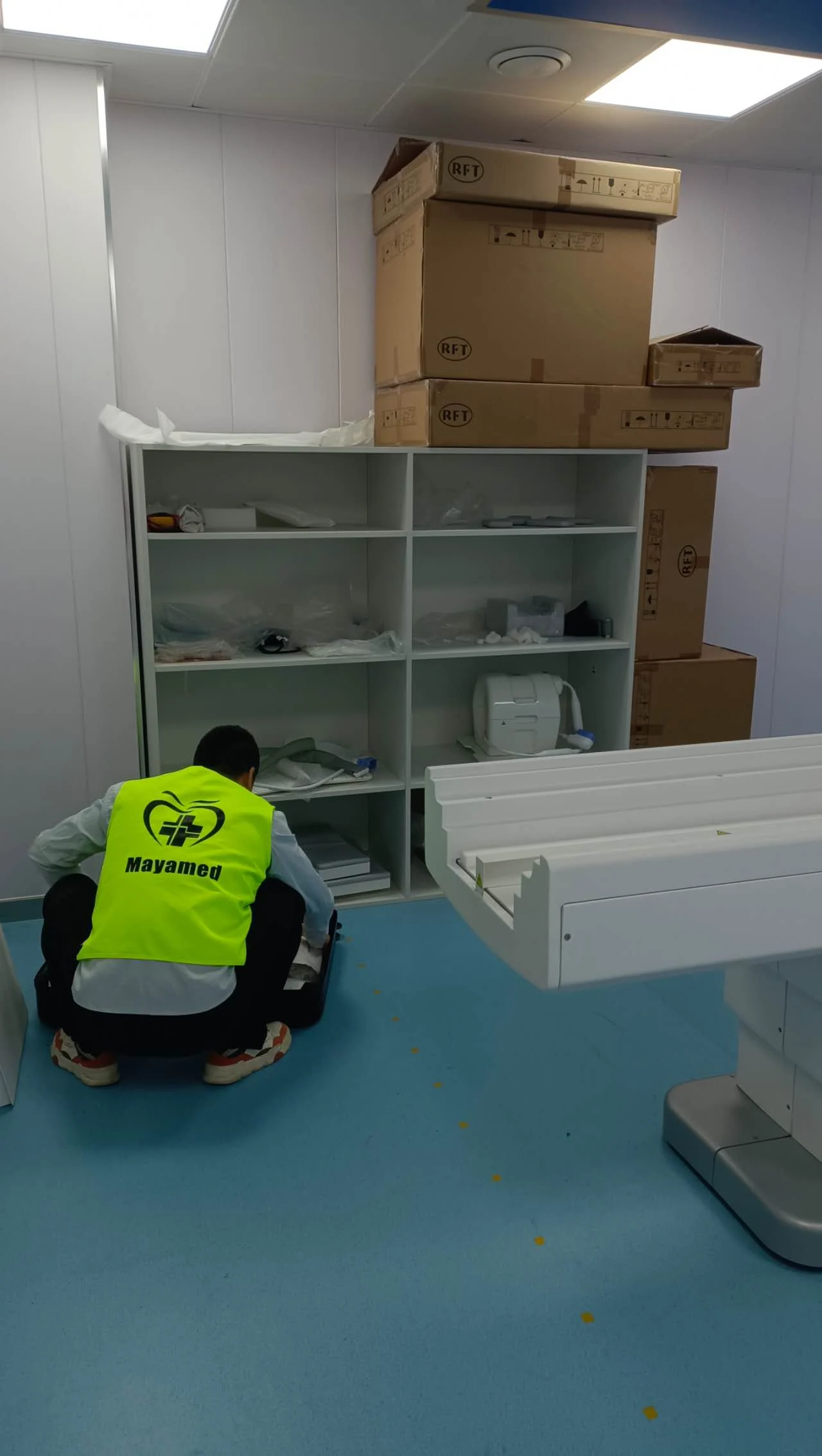 MAYA MEDICAL engineer working beside the MRI patient table in Chad.