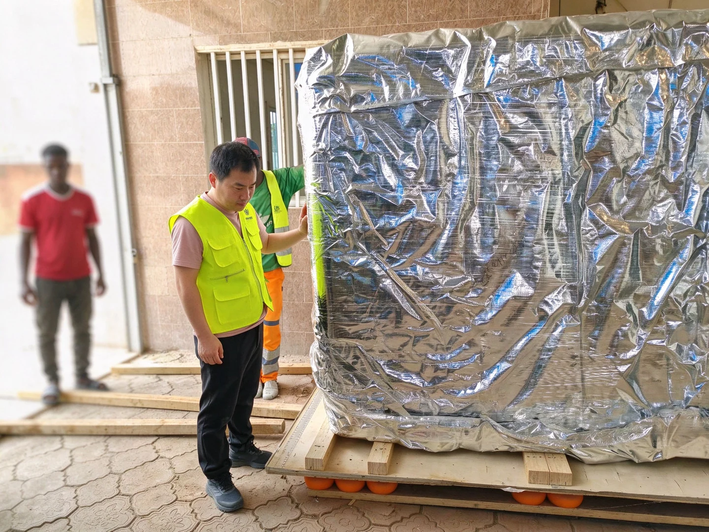Packaged CT equipment being handled at the Senegal project site.